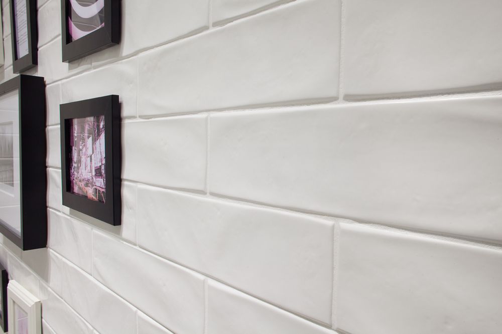 Shows a catalog scene featuring a classic white subway tile with a subtle wavy hand-made texture
