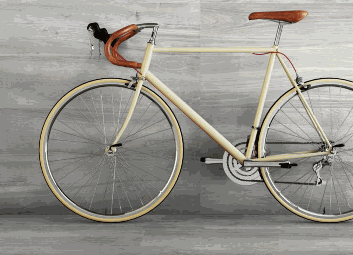 Shows a catalog scene featuring a grey tone wall tile that looks like wooden planks, behind a parked bicycle