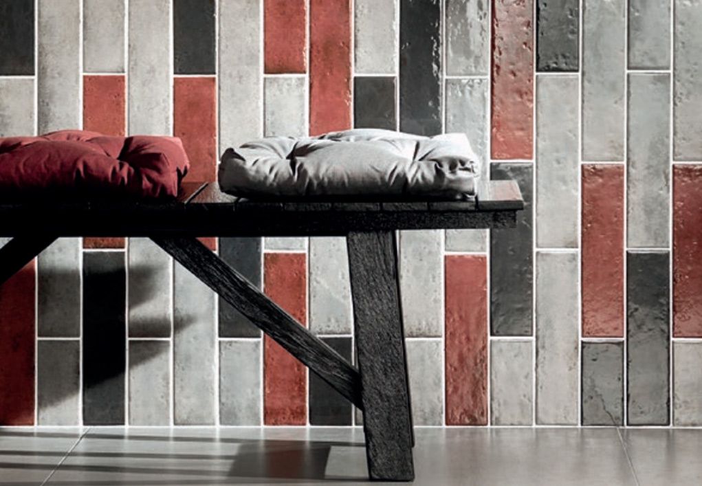 Shows a catalog scene featuring black, white, and red subway tiles arranged in a random contemporary pattern